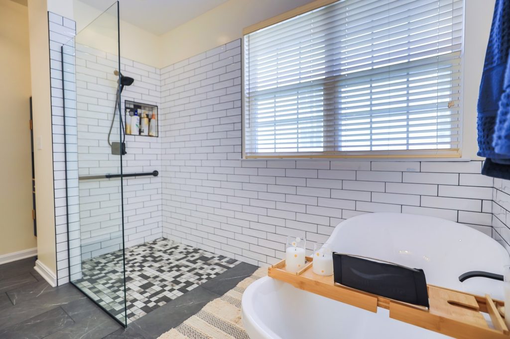 Bathroom remodel with a subway tile walk-in shower, mosaic tile floor and a freestanding tub
